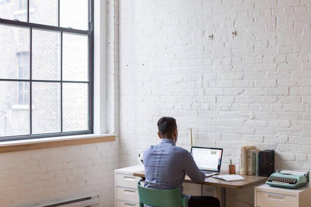 person working at desk with computer